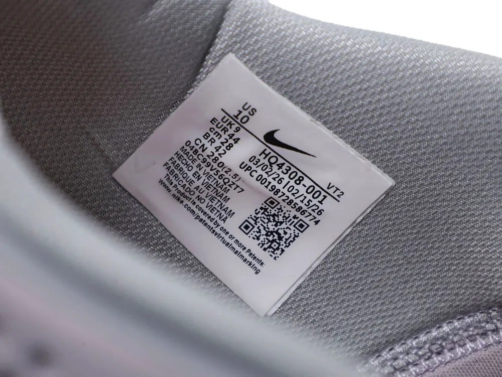 Gray fabric shoe interior with label and QR code.