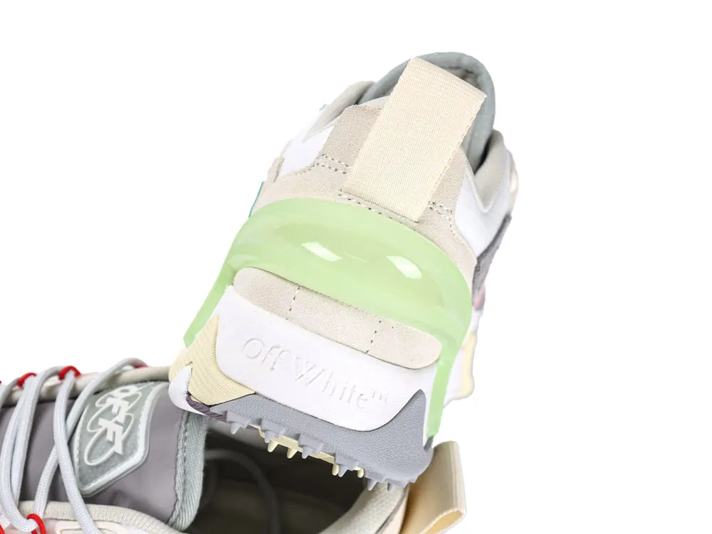 Beige and gray sneaker with green accent, suede material, heel view.