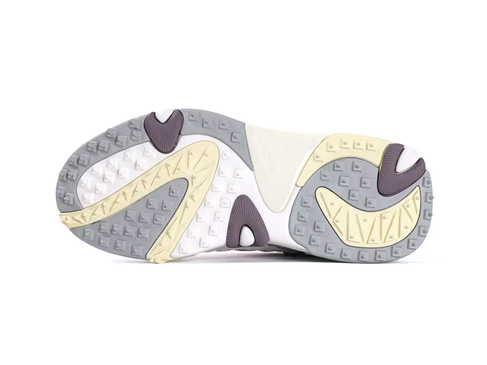 Sneaker outsole with textured gray, yellow, and white rubber for grip and durability.