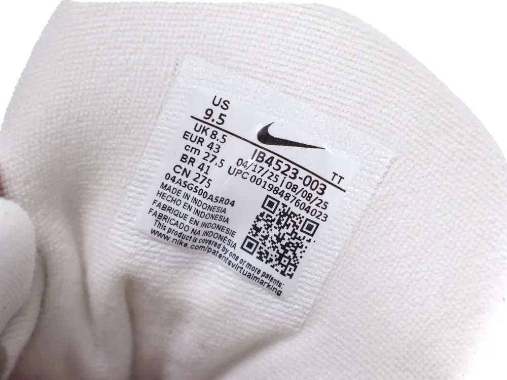 White fabric shoe interior with a label showing size and manufacturing details.