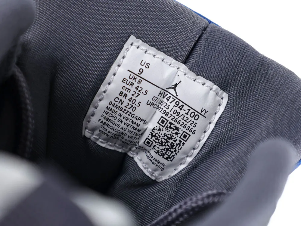 Gray fabric shoe interior with a white label displaying size and manufacturing details.