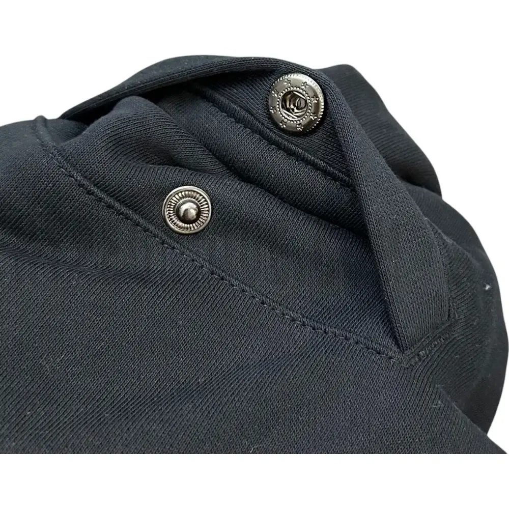 Close-up of button detail on the shorts.