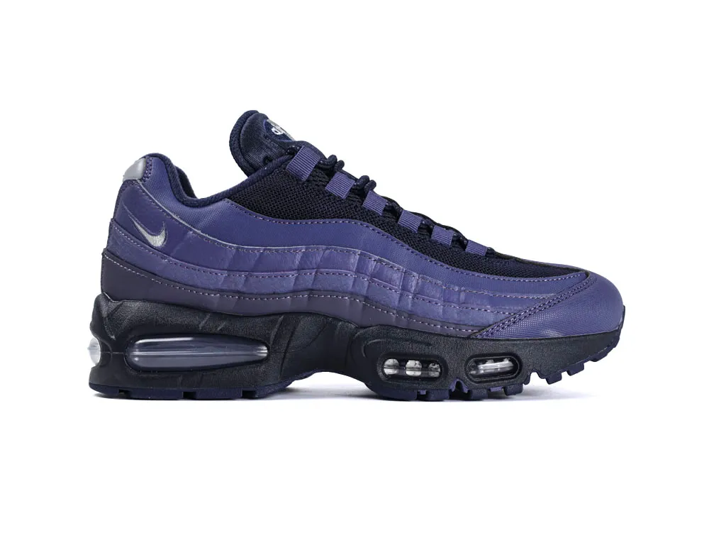 Purple and black sneaker with a mesh and leather upper and visible air sole unit.
