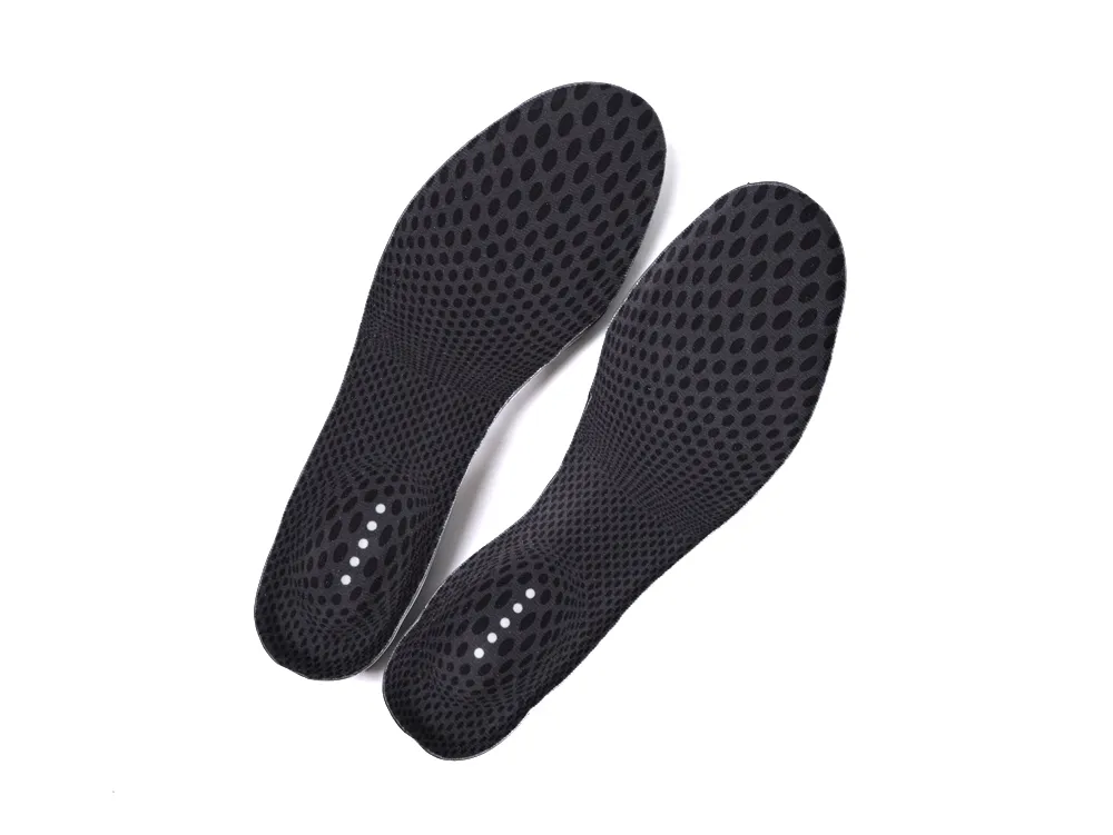 Black, perforated shoe insoles made of flexible material.