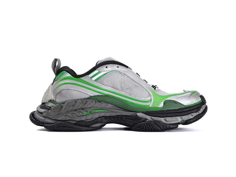 Silver and green mesh athletic shoe with black rubber sole and textured details.