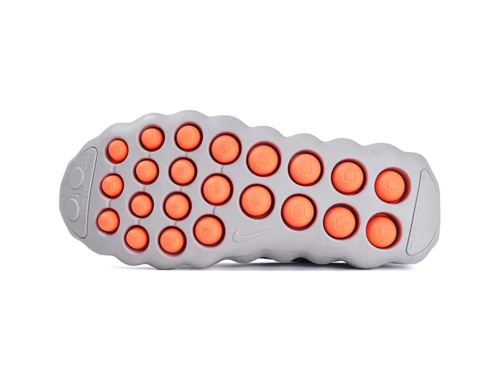 Gray rubber shoe sole with circular orange grips, providing traction and support.