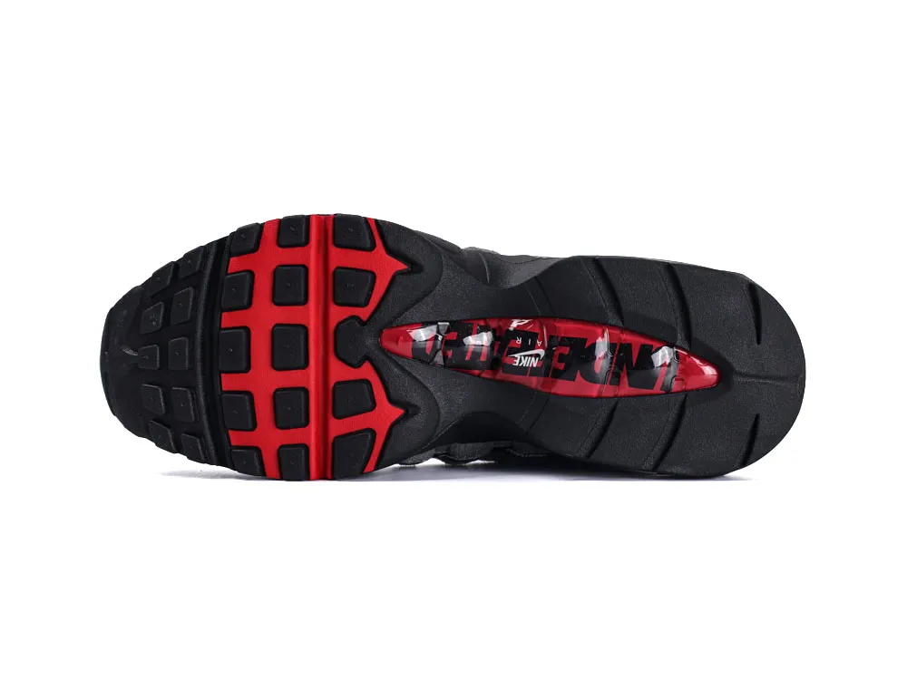 Black and red rubber sneaker sole with detailed tread pattern.
