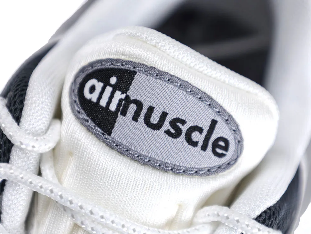White fabric sneaker tongue with black and gray logo label, showing "airmuscle."