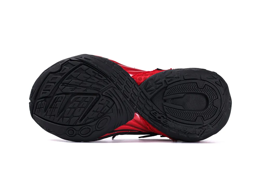 Black rubber outsole with intricate tread pattern, red mesh upper visible.