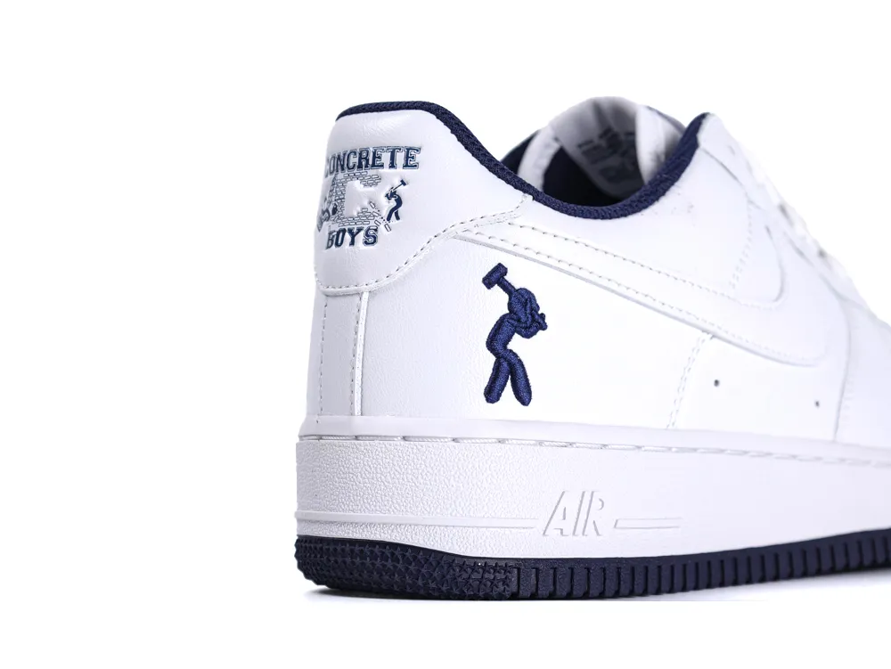 White leather sneaker with blue embroidery on heel and sole detailing.