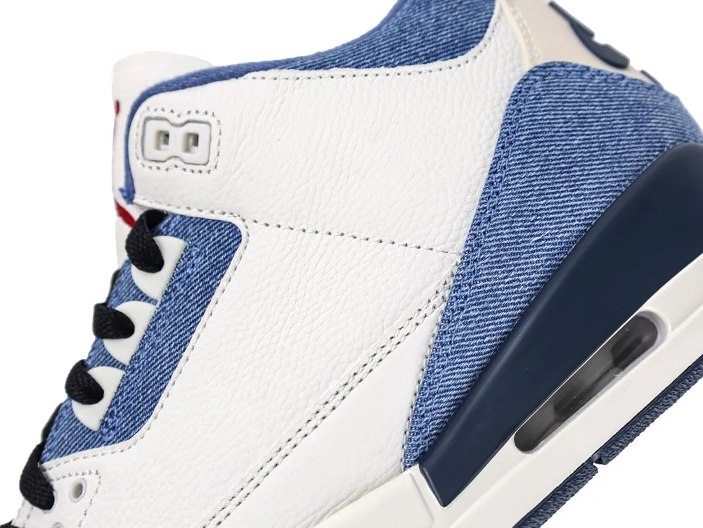 Detailed view of the upper showing white tumbled leather paired with blue denim overlays and navy blue midsole accents.