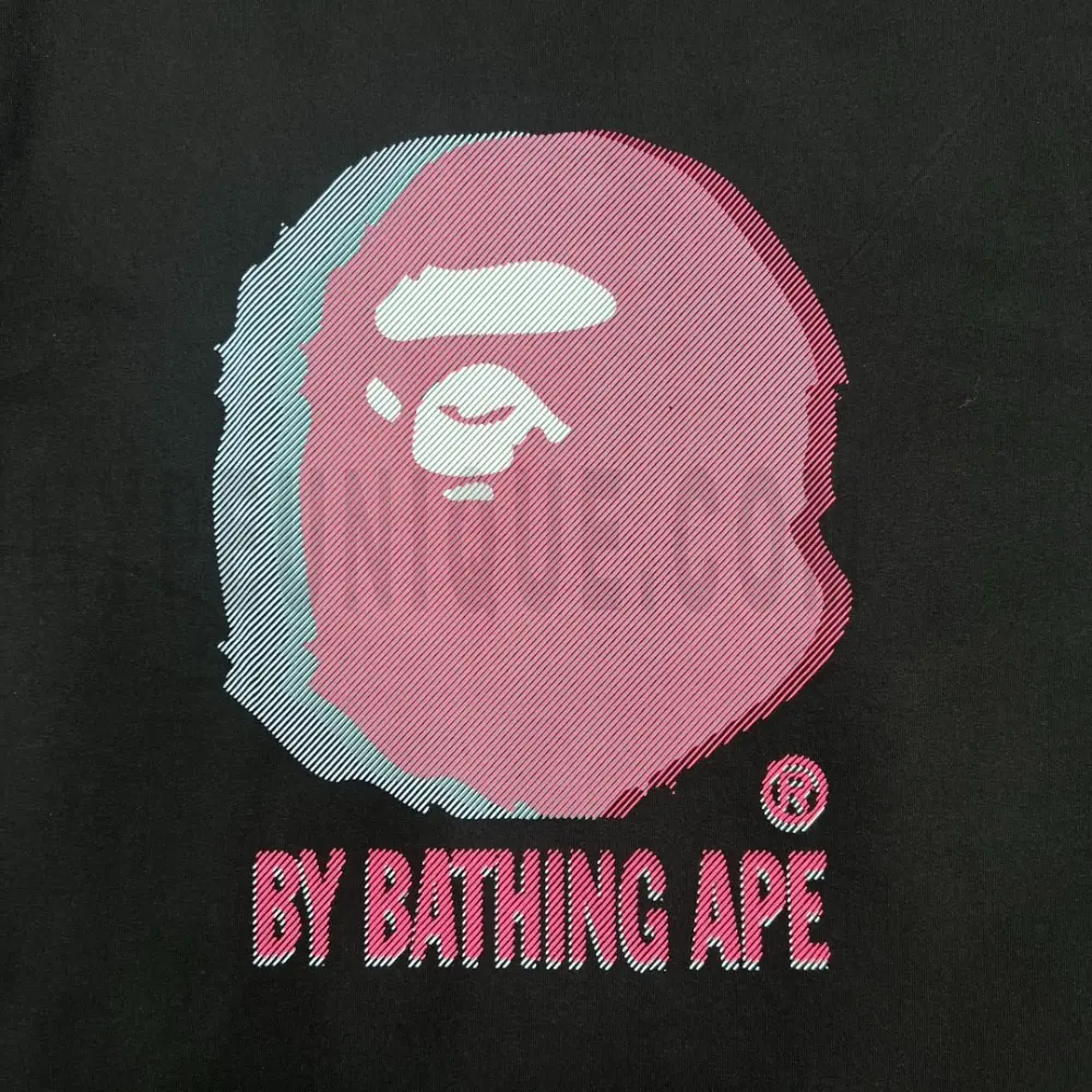 Detailed shot capturing the graphic print on the black tee's front panel.