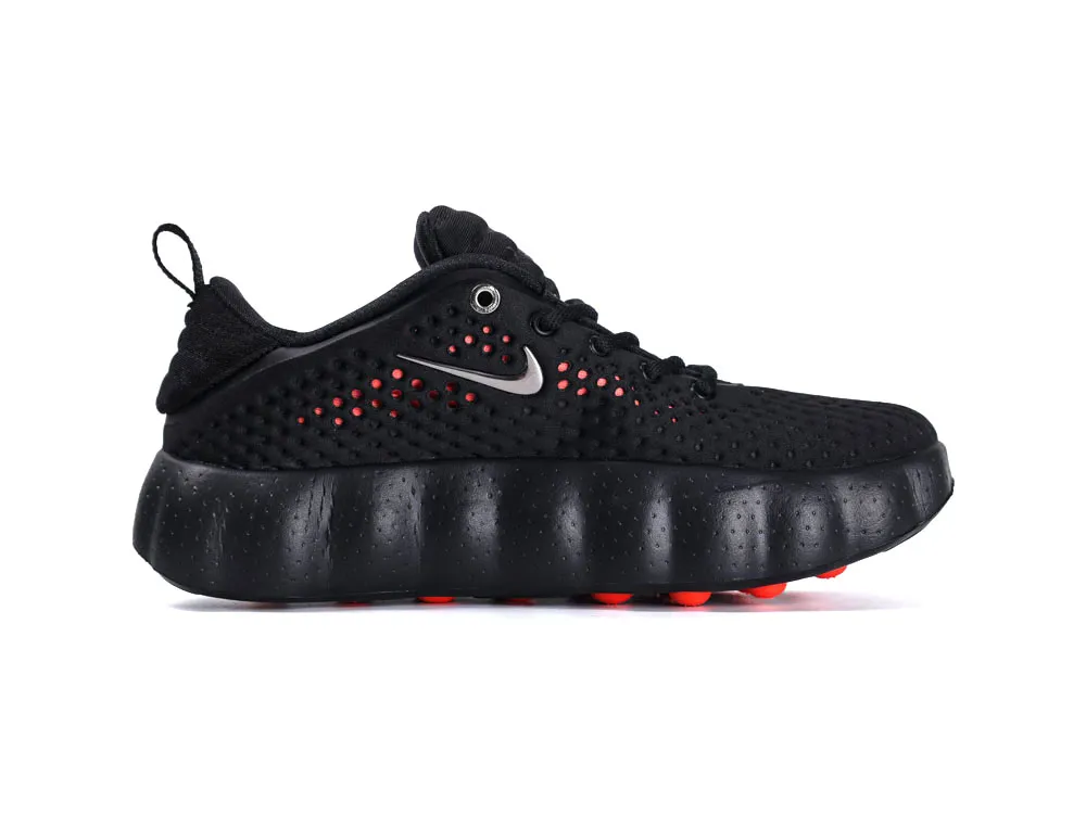 Black mesh sneaker with textured fabric, orange accents, and cushioned sole.