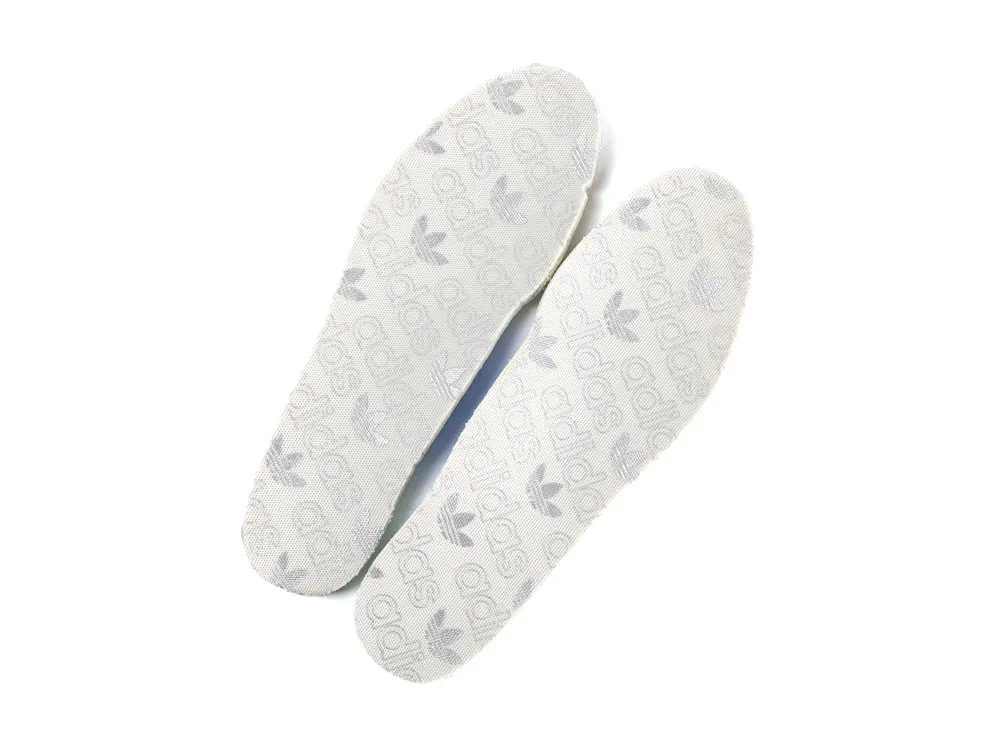 White fabric insoles with gray logos and a soft texture.