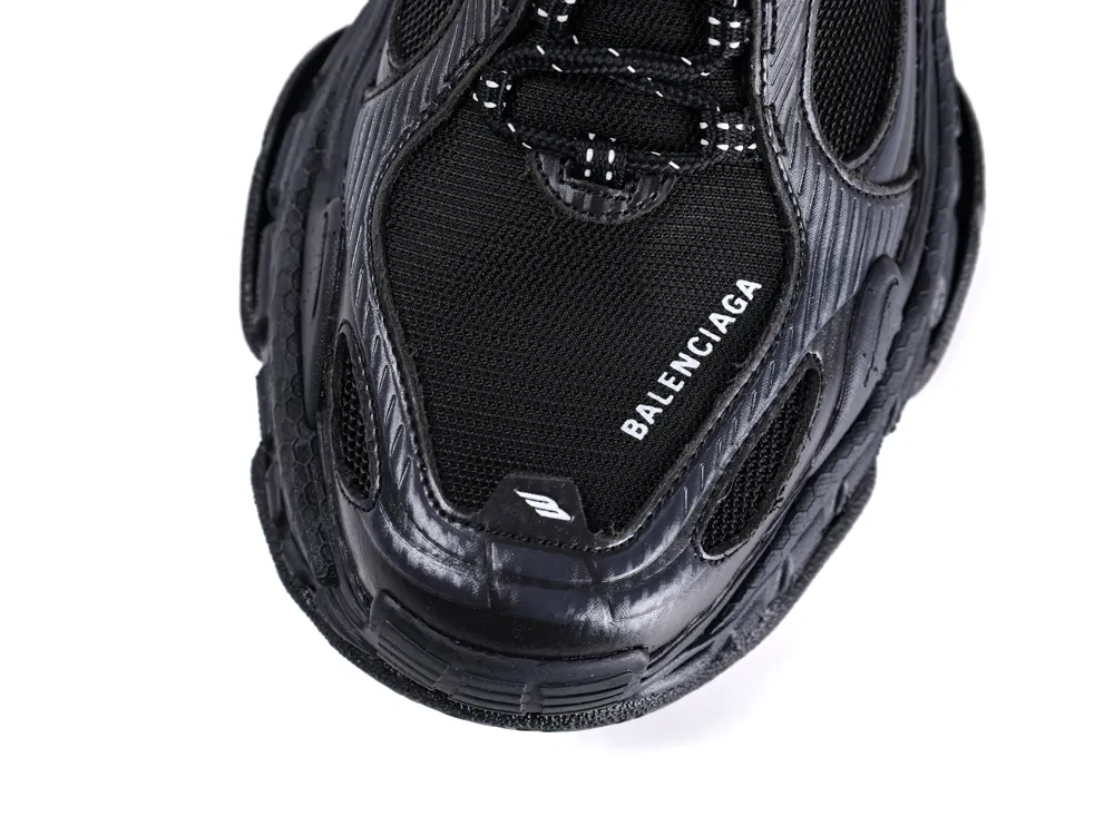Black mesh and leather sneaker with textured design and white logo on the toe.