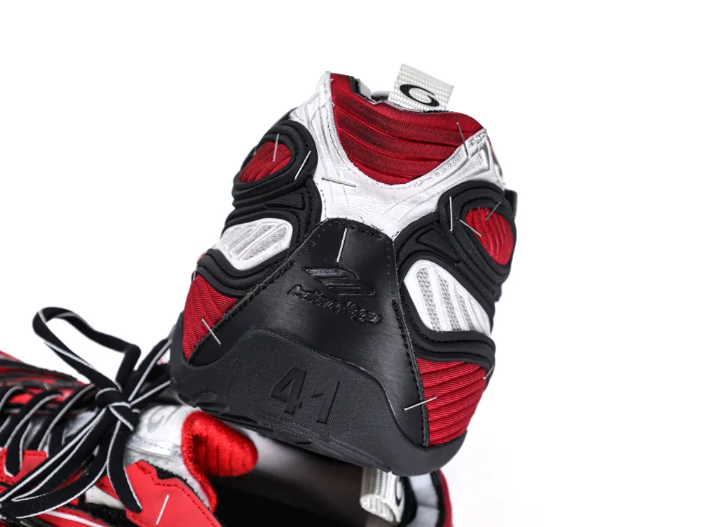 Close-up of a black, red, and white sneaker heel with detailed stitching design.