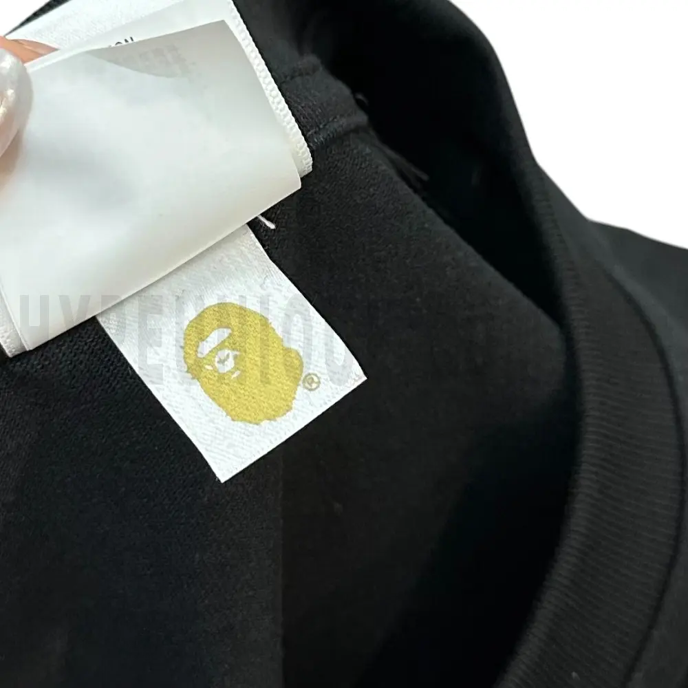 Neckline tag close-up, displaying garment care symbols and brand information with fashion-forward presentation.