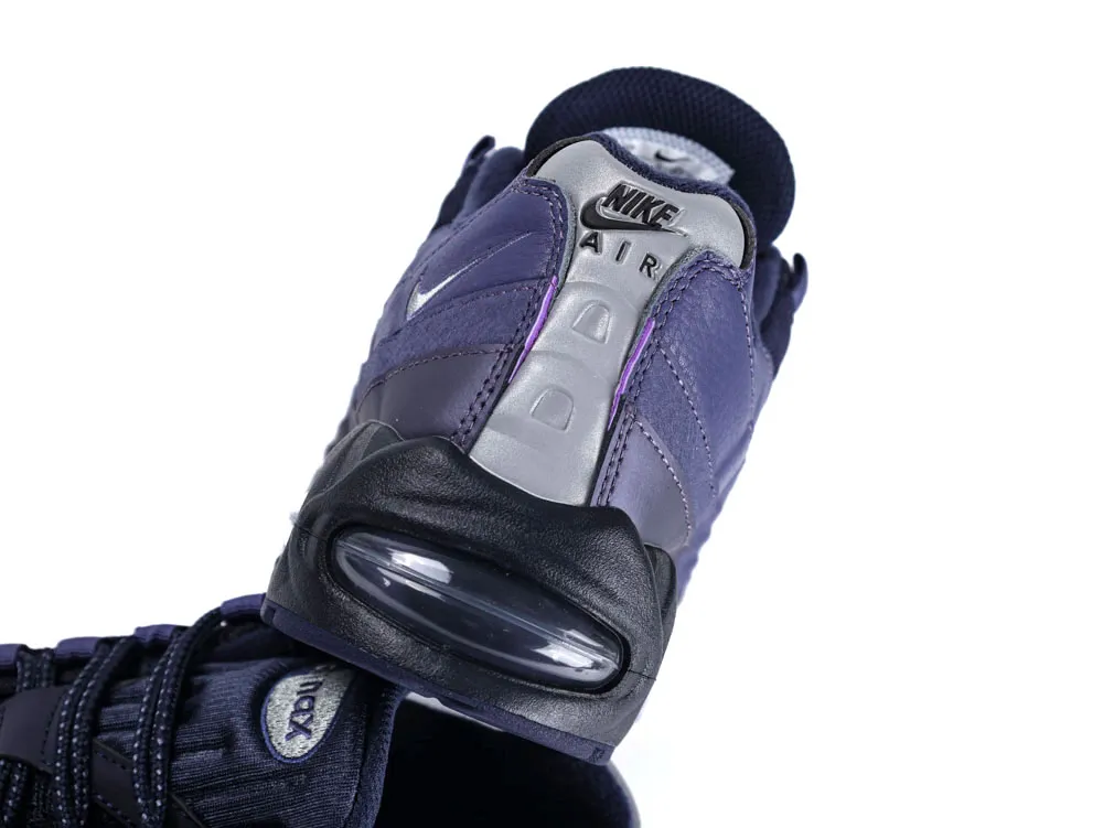 Dark blue and gray sneaker with leather upper and visible air cushion sole.