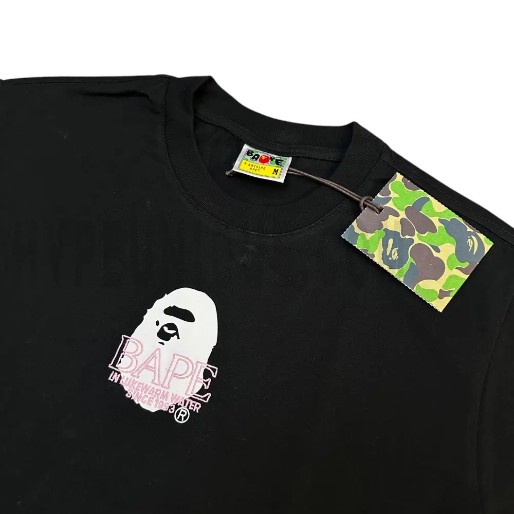 Detailed shot capturing the graphic print on the black tee's front panel.