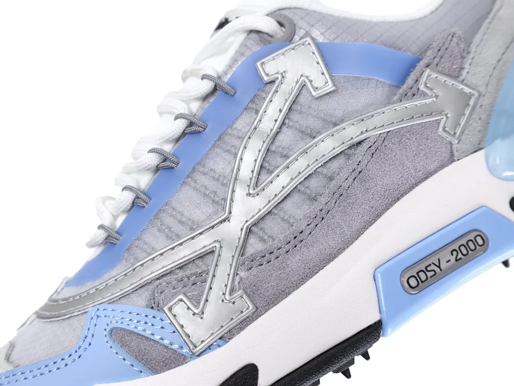 Close-up of a gray and blue sneaker with suede and leather accents.