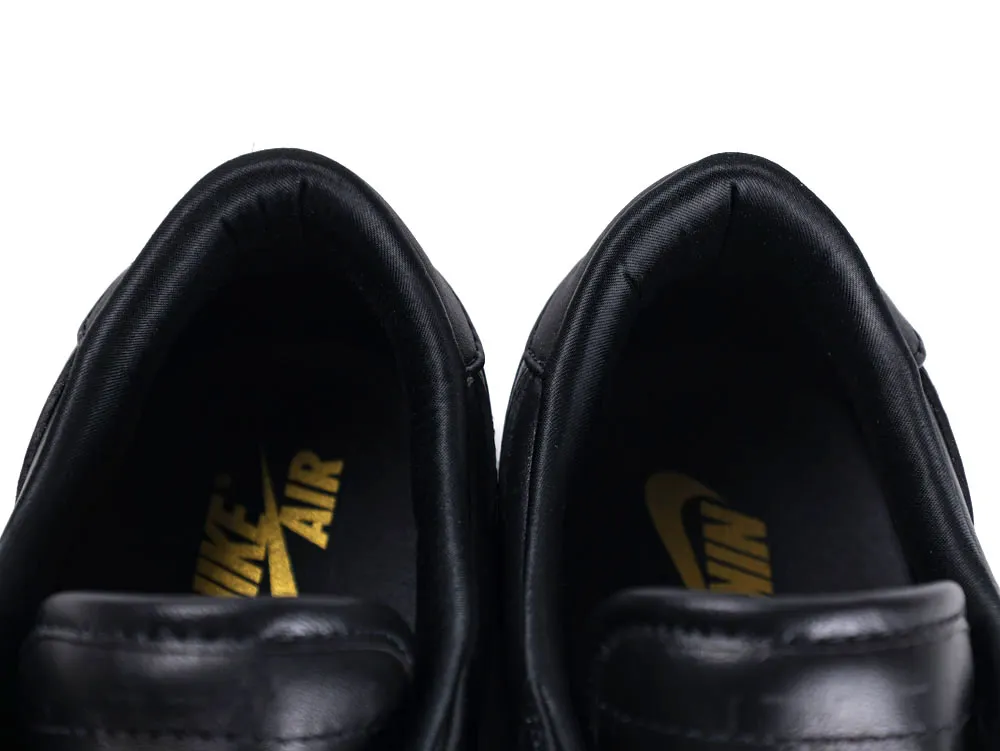 Close-up of black leather shoes with visible insoles and yellow Nike Air logo.