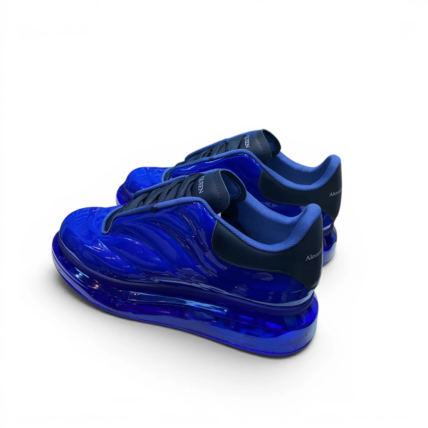 Blue glossy sneakers with transparent soles and textile accents.