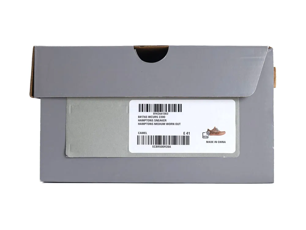 Gray shoebox with product label, featuring camel-colored sneakers, cardboard material.