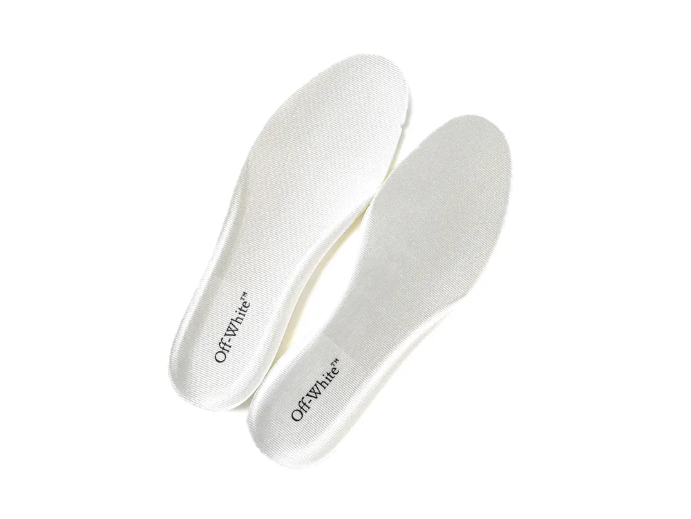 White fabric insoles with textured surface and printed text detail.