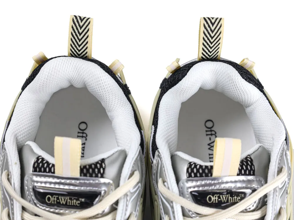 White and black sneakers with mesh lining, fabric tabs, and beige accents.