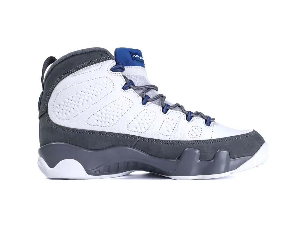 Gray and white sneaker with leather upper, blue lace accents, and rubber sole.