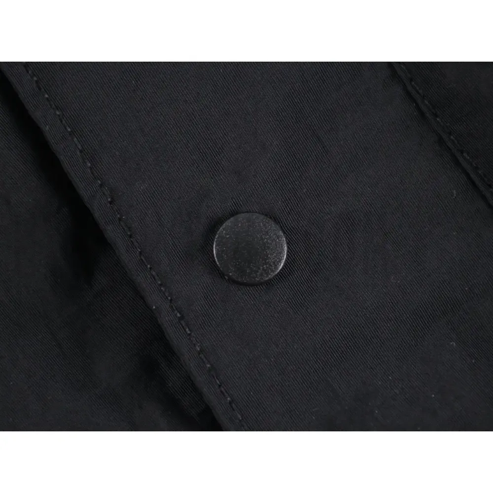 Close-up of button detail on the pants