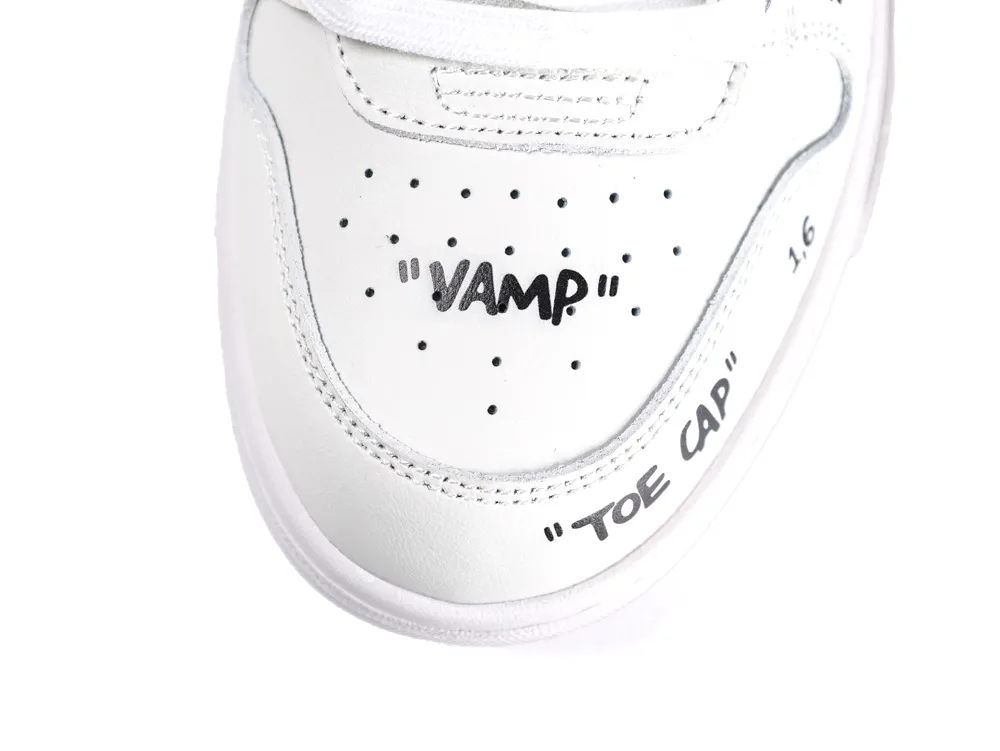 White leather sneaker showing toe cap and vamp details with black text.