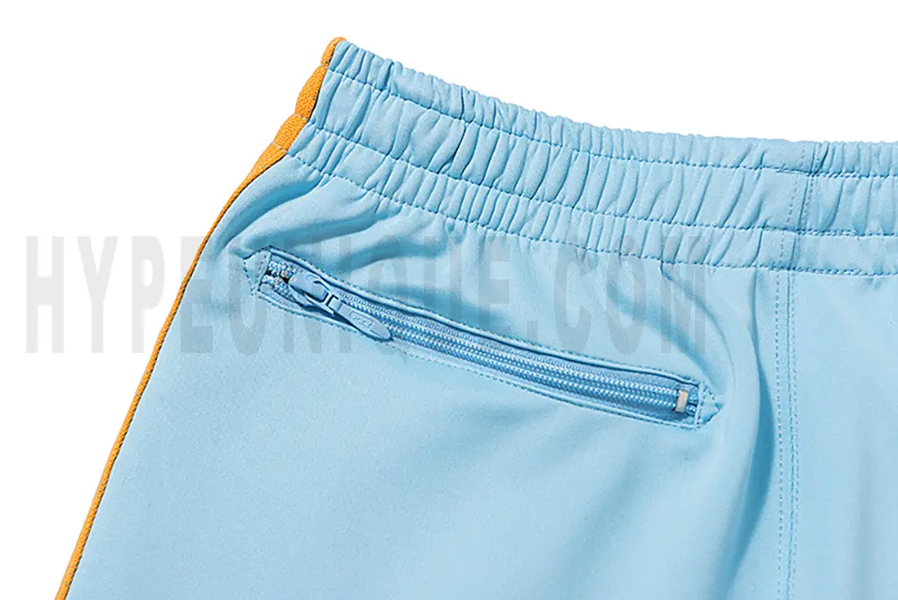 Detail of the back zip pocket on the track pants.