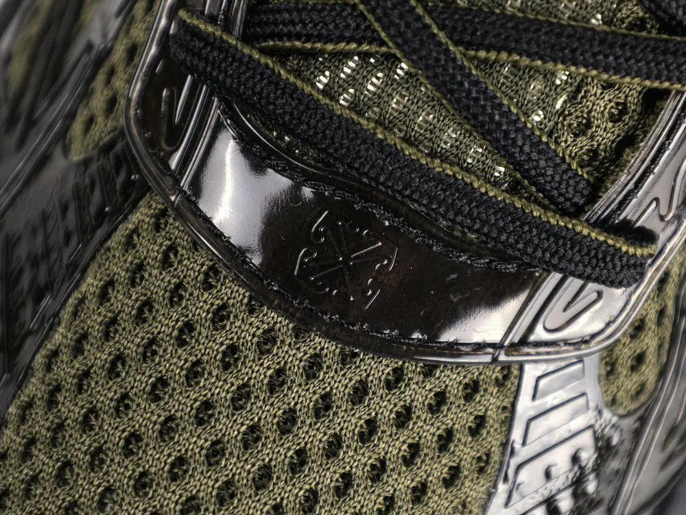 Detailed view of Off-White logo window on tongue area of Black Be Right Back trainer