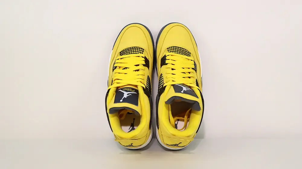 A top-down view of the entire Jordan 4 Retro ‘Lightning’ (2021) shoe, showcasing the overall yellow leather upper material