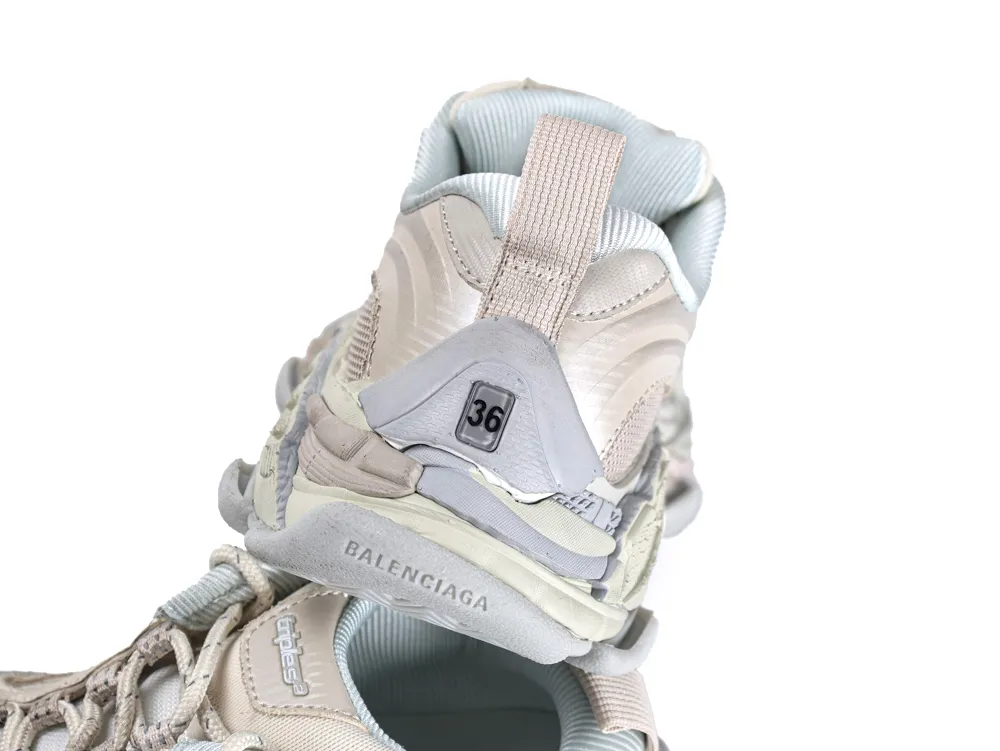 Light gray and beige sneaker featuring mesh fabric and rubber sole, focusing on heel.