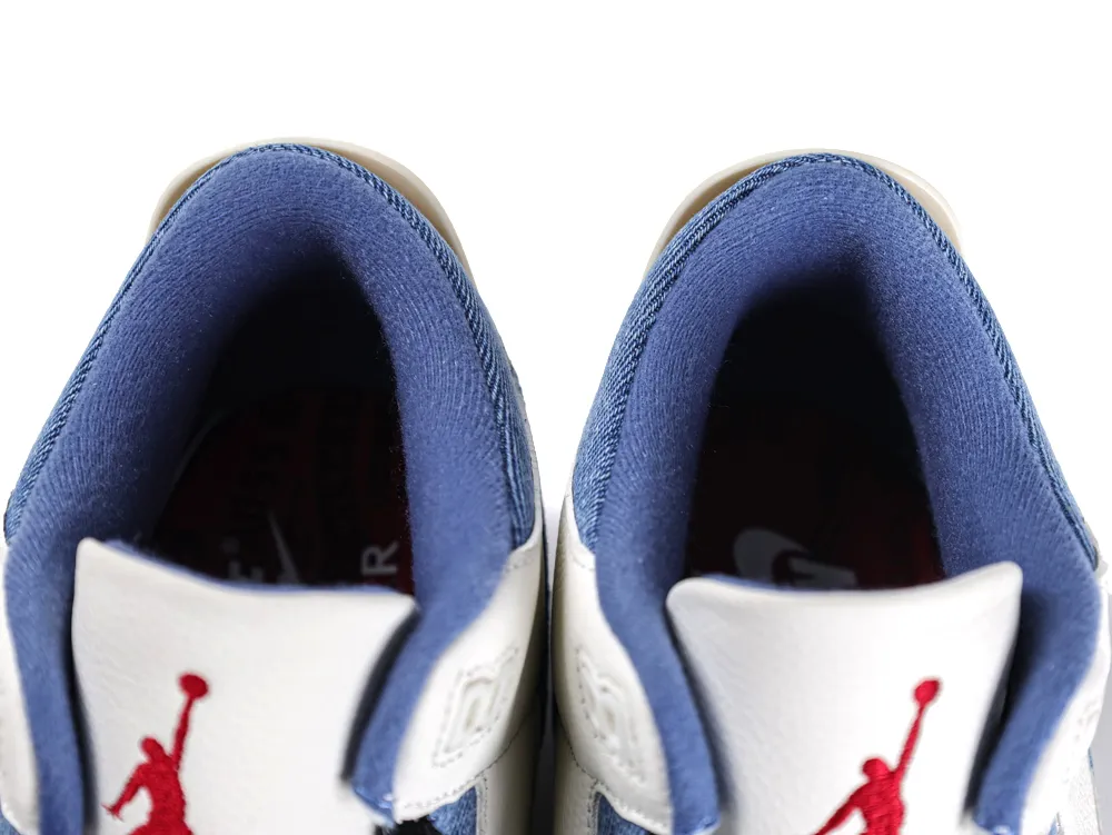 Top-down view showing the padded blue denim ankle collar and the white leather tongues with red Jumpman logos.